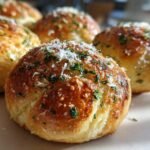 Close-up of Delicious Garlic Parmesan Knots, sprinkled with fresh parsley and grated Parmesan cheese.