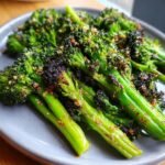 Close-up of tender, roasted broccoli florets coated in garlic and parmesan cheese.