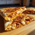Close-up of Irresistible Chicken Quesadillas With Jalapeño Cheese, showing shredded chicken and melted cheese.
