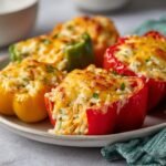 Close-up of Irresistible Cream Cheese Stuffed Peppers filled with rice and topped with melted cheese.