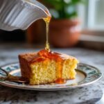 Close-up of a slice of cornbread being drizzled with Irresistible Hot Honey.
