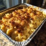 Close-up of Irresistible Memorial Day Smoked Mac and Cheese in a foil pan, with a golden-brown breadcrumb topping.