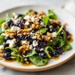 A refreshing blueberry salad with walnuts, feta cheese, and a light dressing, perfect for summer.