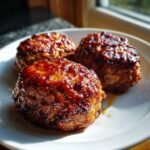 Three shiny, glazed Mini Turkey Meat Loaves Without Ketchup served on a white plate.
