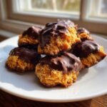 A stack of freshly made Homemade Tagalong Cookies, featuring a peanut butter base dipped in melted chocolate.