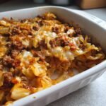 Close-up of a baked Unstuffed Cabbage Rolls casserole featuring ground meat and tender cabbage in a white baking dish.