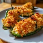 Close-up of baked Seafood Jalapeno Poppers with a crispy, golden breadcrumb topping served on a white plate.
