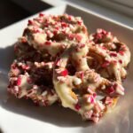 Close-up of White Chocolate Peppermint Pretzels dipped in white chocolate and covered in crushed candy canes.