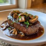 A perfectly cooked steak smothered in rich Hunters Sauce and topped with sliced mushrooms and parsley.